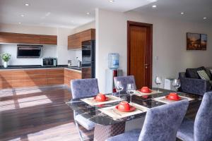 a kitchen and dining room with a glass table and chairs at Viet Vuong Building Ha Noi Capital in Hanoi