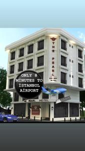 a white building with a sign in front of it at The Pearl Airport Hotel in Arnavutköy