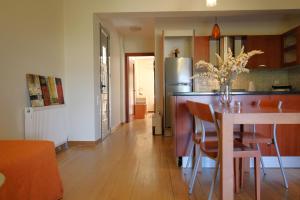 a kitchen and dining room with a table and a refrigerator at Loli's sea view apartment in Argostoli