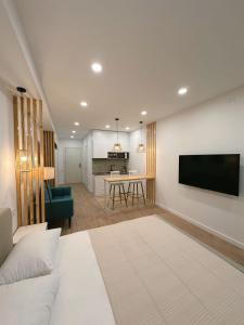 a living room with a couch and a flat screen tv at MIKASA Studio in Kobuleti +42 photos