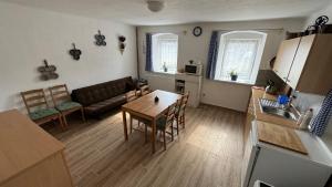 a kitchen and living room with a table and a couch at Ubytování Bauštel in Kochovice