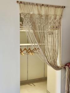 a curtain in a room with a closet at La maison Marilyne - T2 avec piscine privative in Aix-les-Bains +13 photos