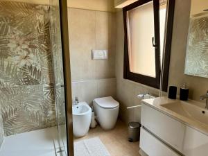 un bagno con doccia, WC e lavandino di Villa Oliva in Quartu Sant Elena, Capitana, with big Garden and Sea view! a Capitana Altre 98 foto
