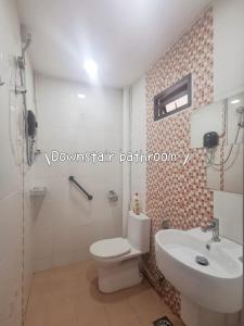 a bathroom with a white toilet and a sink at Near TC Beach Alor Akar 4R3B fully AC Town area in Kuantan