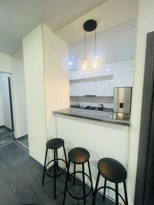 a kitchen with two bar stools and a counter at My Sweet Homi in Rustavi Sity 11 in Rustavi