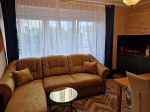 a living room with a couch and a large window at WILLA VASCO NAWIGATOR in Rewa