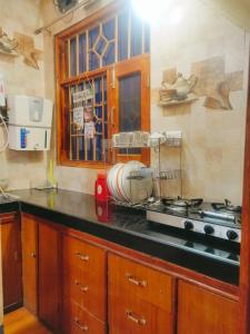 a kitchen with a mixer on top of a stove at Thakur Apartment in Shimla +14 photos