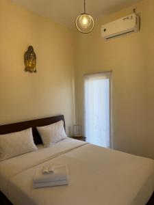 a bedroom with a bed with a tray on it at Bali Bliss ArtVilla in Uluwatu