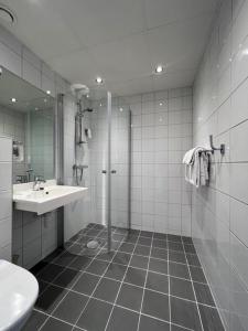 a bathroom with a shower and a sink at Oppdal Turisthotell in Oppdal