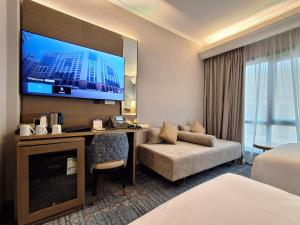 a hotel room with a bed and a tv at MADEN Taiba HOTEL in Medina