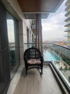 a chair on the balcony of a building with a view at Ap by Zora Navodari in Năvodari
