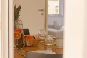 a table with a glass vase and a bowl of oranges at TAIGA Almeria Playa in Palomares