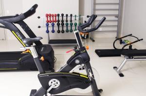 a gym with two exercise bikes and a treadmill at CEU PALMAS Hotel in Palmas