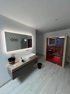a bathroom with a sink and a red refrigerator at Bien-Être au B in Sart-lez-Spa