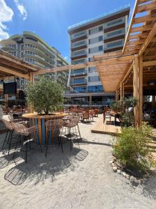 a patio with a table and chairs and a building at Ap by Zora Navodari in Năvodari