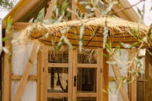 a bird house with a thatched roof at TAIGA Almeria Playa in Palomares