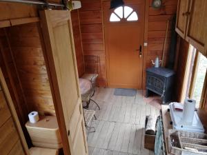 an inside view of a room with a stove at Roulotte en total déconnection in Foulain