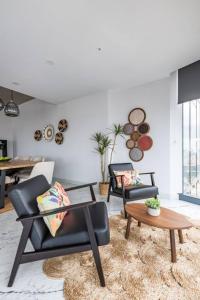 a living room with two chairs and a table at Gorgeous 3bd2bath Bright Airy Penthouse! #355 in Istanbul