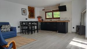 a living room with a blue couch and a kitchen at Val de ver in Pol +7 photos