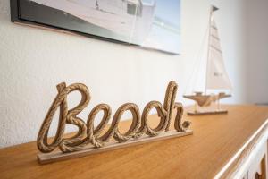 a wooden table with a sign that says bacon on it at Stern FeWo Strandstraße in Ostseebad Karlshagen +135 photos