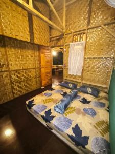 a room with a large bed in a roomthritisthritisthritisthritisthritisthritisthritis at Sama Sama Homestay & Trekking Only Stay Here Book Trekking and Transport With Us in Bukit Lawang