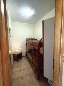 a small room with a bunk bed and a table at Apartment Girasole in Acquedolci +7 photos