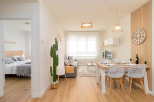 a bedroom and a living room with a table and a bed at HOME IN CASTRO con PARKING in Castro-Urdiales +20 photos