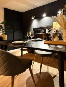 a dining room with a table and chairs with wine glasses at Gemütliche Hygge Cabin in Buttelstedt