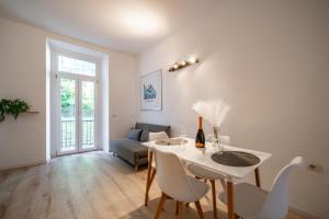 a living room with a white table and chairs at Renzo & Lucia Living Lake in Malgrate