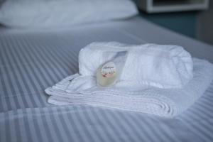 a white towel on top of a bed at Fofi's House in Agii Saranta +53 photos