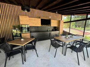 a dining room with two tables and chairs and a television at B&B rooms in Zgorigrad