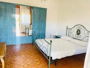 una camera da letto con un letto con pareti blu e una finestra di Palma Verde a Castello di Brussa