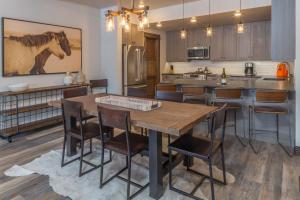 a kitchen with a large wooden table and chairs at Mountain Lake Condo - Unit 102B in Big Sky