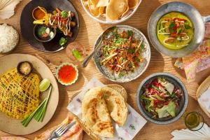 a table with plates of food and bowls of food at Eco Boutique Villa in Gurudeniya