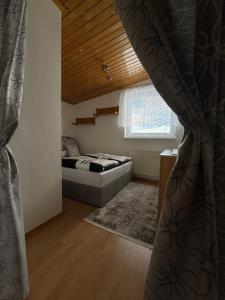 a bedroom with a bed and a window at 3-izbový dom v kľudnej lokalite in Spišská Belá