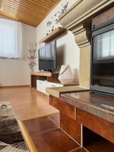 a living room with a fireplace and a television at 3-izbový dom v kľudnej lokalite in Spišská Belá