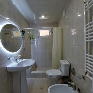 a bathroom with a sink and a toilet and a mirror at KOTE.GE in Lagodekhi +66 photos
