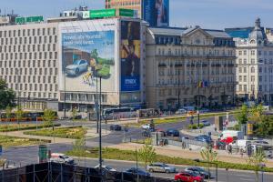 a busy city street with cars and buildings at Beautiful Apartment with Balcony in Heart of Warsaw by Noclegi Renters in Warsaw +15 photos