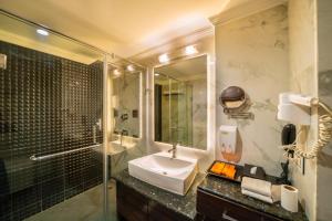 a bathroom with a sink and a shower at Hotel Saffron Leaf in Dehradun +37 photos