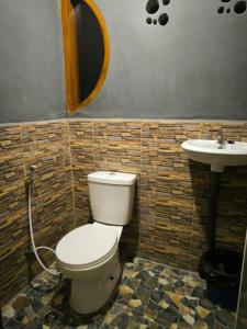 a bathroom with a toilet and a sink at Sama Sama Homestay & Trekking Only Stay Here Book Trekking and Transport With Us in Bukit Lawang