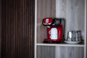 a coffee maker on a shelf in a room at Rafiki Rooms in Nydri