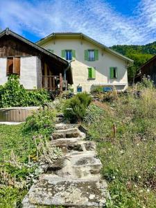 a stone path in front of a house at Duplex familial à la campagne in Orcier