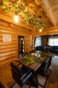 a wooden dining room with a table and chairs at Casa Bucuriei - Plaiul Foii, Zărnești in Zărneşti +60 photos