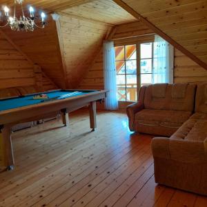 a living room with a pool table and a couch at Góralski Domek Na Skarpie in Piwniczna Zdrój +53 photos