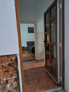 a door leading into a room with a bedroom at APARTMENT POPS in Cluj-Napoca
