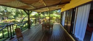 a porch with a table and chairs on it at Maison Angèle in Nosy Be