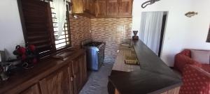 a kitchen with a counter top in a room at Maison Angèle in Nosy Be