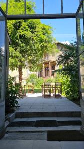 a patio with tables and chairs in front of a building at Bed in 6-Bed Mixed Dormitory Le Jardin Cafe in Bordeaux