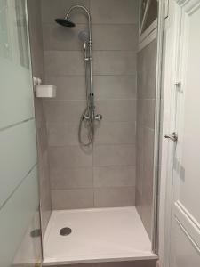 a shower with a glass door in a bathroom at Bed in 6-Bed Mixed Dormitory Le Jardin Cafe in Bordeaux