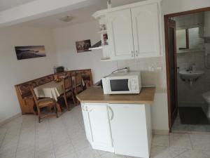 a kitchen with a microwave on top of a counter at Apartments Brkanac in Umag